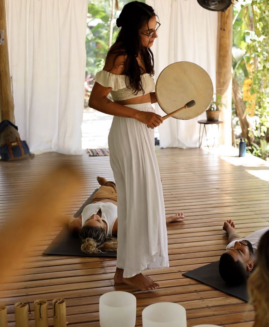 Breathwork facilitator with drum at Al Deck